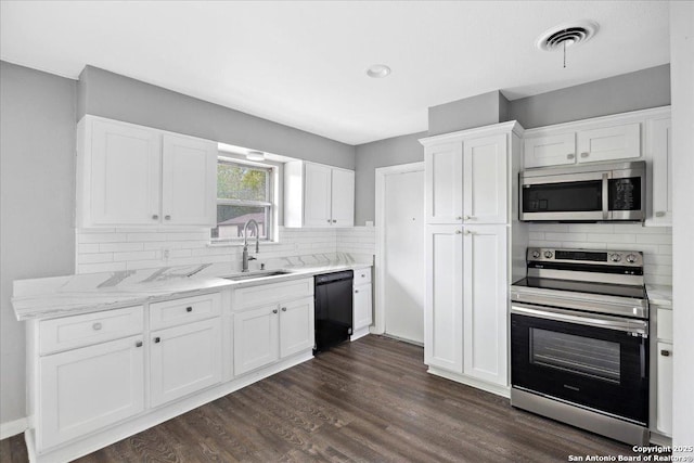 910 Mount Kisco, San Antonio, TX 78213 - kitchen featuring stainless steel appliances, decorative backsplash, white cabinetry, dark wood-type flooring, and recessed lighting