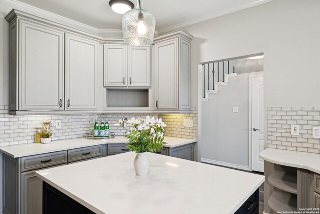 4130 Luckenbach, San Antonio, TX 78251 - kitchen featuring gray cabinets, light countertops, tasteful backsplash, and crown molding