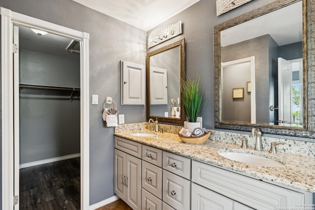 4130 Luckenbach, San Antonio, TX 78251 - bathroom with double vanity, wood finished floors, and a spacious closet