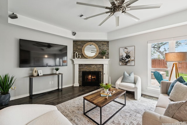 4130 Luckenbach, San Antonio, TX 78251 - living area with wood finished floors, a ceiling fan, and a warm lit fireplace