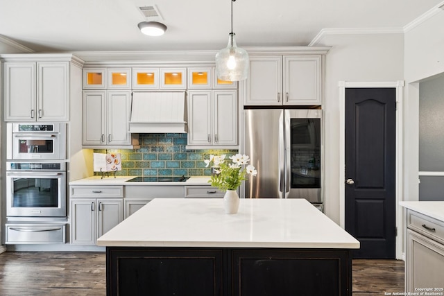 4130 Luckenbach, San Antonio, TX 78251 - kitchen featuring a warming drawer, stainless steel appliances, custom exhaust hood, crown molding, and decorative light fixtures