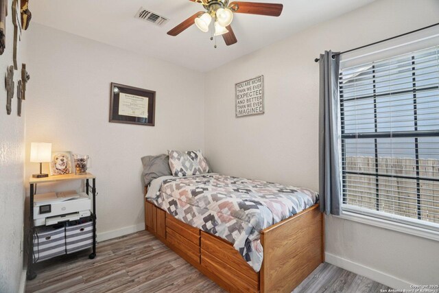 714 N Esplanade, Karnes City, TX 78118 - bedroom with wood finished floors and ceiling fan