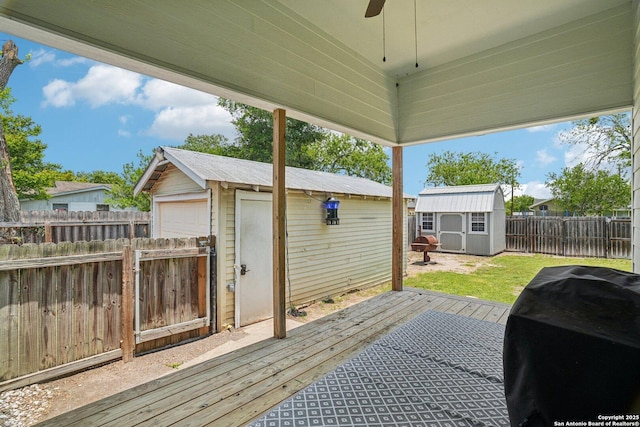 714 N Esplanade, Karnes City, TX 78118 - deck with a ceiling fan, a shed, a fenced backyard, a grill, and a detached garage