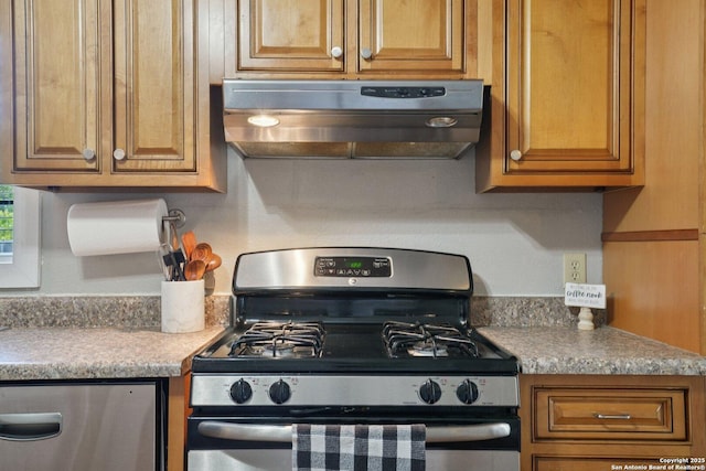 714 N Esplanade, Karnes City, TX 78118 - kitchen with stainless steel appliances, under cabinet range hood, brown cabinets, and light countertops