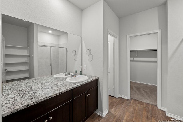 14034 Breccia, San Antonio, TX 78253 - bathroom featuring a spacious closet, a shower stall, wood finished floors, and vanity