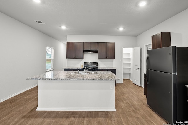 14034 Breccia, San Antonio, TX 78253 - kitchen featuring freestanding refrigerator, dark brown cabinets, under cabinet range hood, light wood-style flooring, and recessed lighting