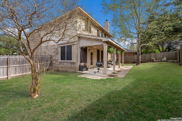 21731 Cliff Vw, San Antonio, TX 78259 - back of property with a chimney, a patio area, a fenced backyard, and brick siding