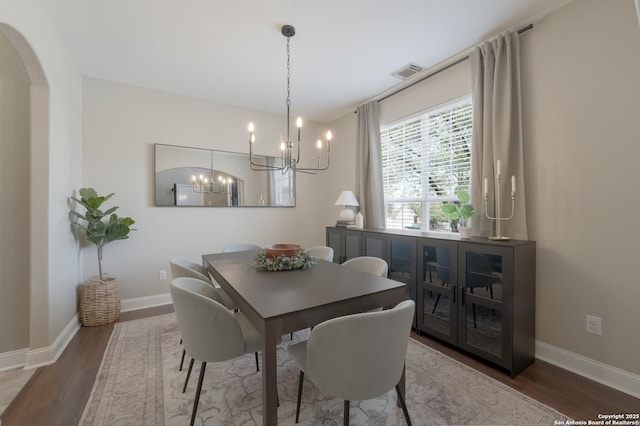 21731 Cliff Vw, San Antonio, TX 78259 - dining room with arched walkways, wood finished floors, and a chandelier