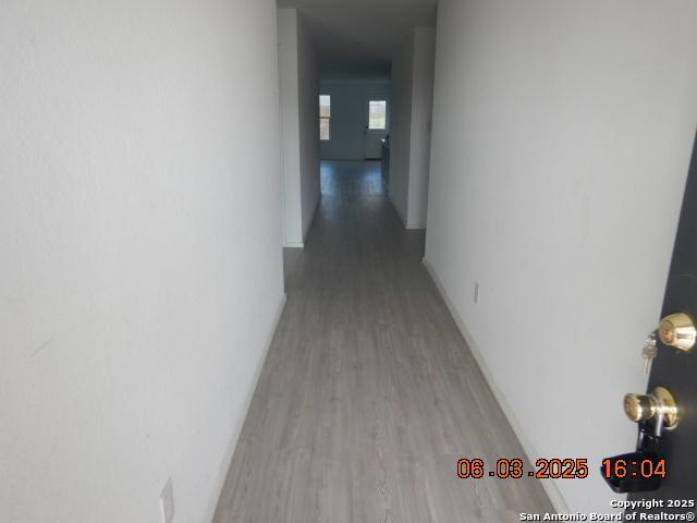 10751 Margarita Loop, Converse, TX 78109 - hallway featuring light wood-style floors and baseboards