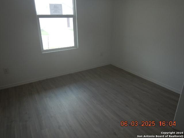 10751 Margarita Loop, Converse, TX 78109 - spare room with wood finished floors and baseboards