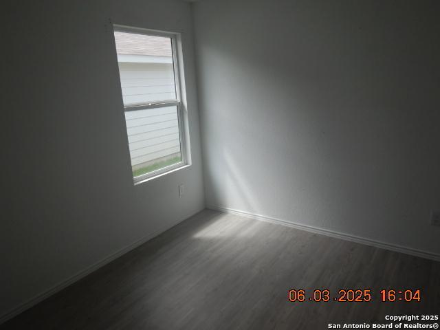 10751 Margarita Loop, Converse, TX 78109 - empty room with wood finished floors and baseboards