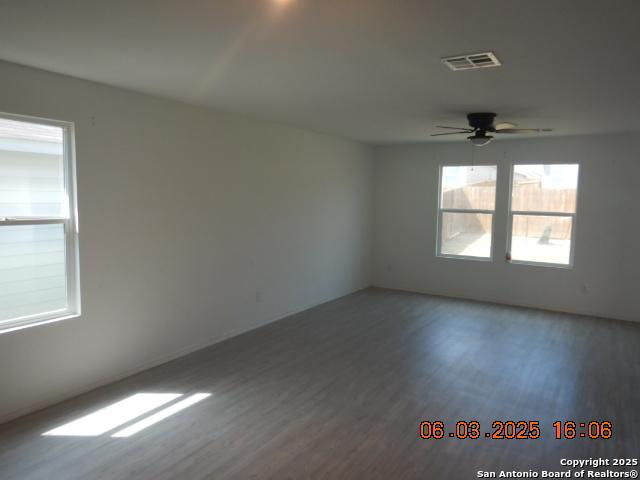 10751 Margarita Loop, Converse, TX 78109 - empty room with wood finished floors and ceiling fan