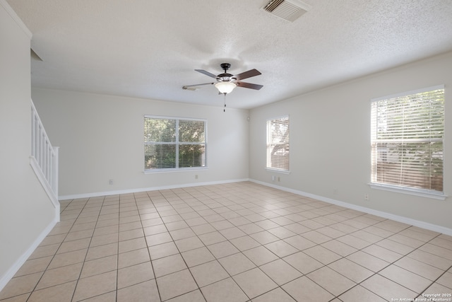 10217 Sandbrook, San Antonio, TX 78254 - spare room with healthy amount of natural light, a ceiling fan, a textured ceiling, stairway, and light tile patterned flooring