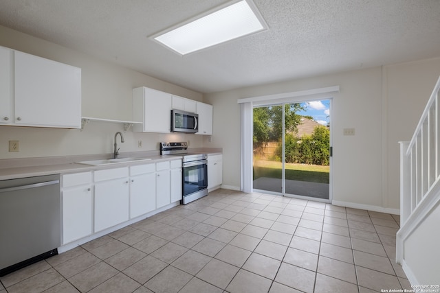10217 Sandbrook, San Antonio, TX 78254 - kitchen featuring stainless steel appliances, a textured ceiling, light countertops, and white cabinetry