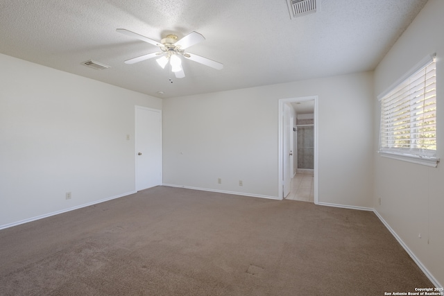 10217 Sandbrook, San Antonio, TX 78254 - unfurnished bedroom with carpet floors, ensuite bath, a ceiling fan, and a textured ceiling