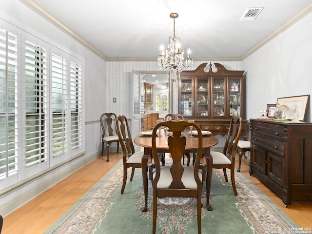 16018 Alsace, San Antonio, TX 78232 - dining space featuring ornamental molding, healthy amount of natural light, a chandelier, and light wood finished floors