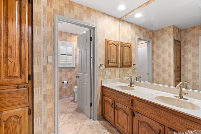 16018 Alsace, San Antonio, TX 78232 - full bathroom featuring double vanity, tile patterned flooring, and wallpapered walls