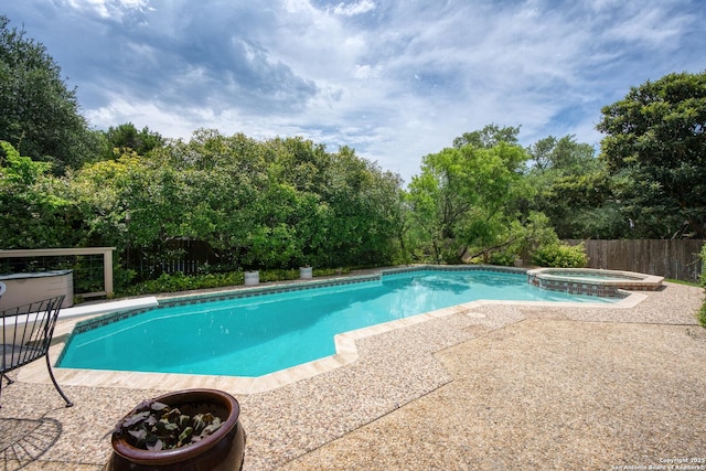 16018 Alsace, San Antonio, TX 78232 - view of pool featuring a patio area, a pool with connected hot tub, and view of wooded area