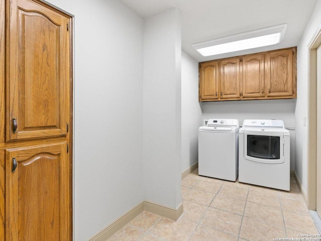 16018 Alsace, San Antonio, TX 78232 - washroom featuring cabinet space, washer and dryer, and light tile patterned flooring