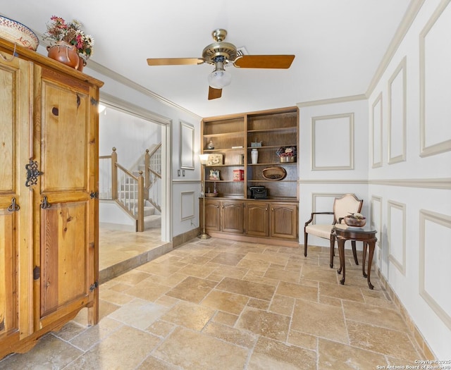 16018 Alsace, San Antonio, TX 78232 - sitting room with stone tile floors, a decorative wall, stairs, ceiling fan, and crown molding