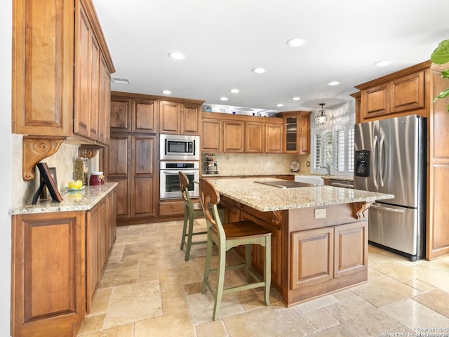 16018 Alsace, San Antonio, TX 78232 - kitchen featuring stainless steel appliances, brown cabinetry, stone tile floors, recessed lighting, and a breakfast bar area