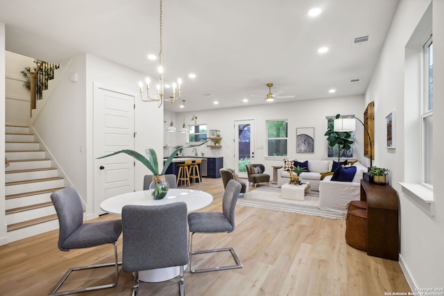 1939 W French Pl, San Antonio, TX 78201 - dining area featuring stairway, light wood-style floors, a ceiling fan, recessed lighting, and a chandelier