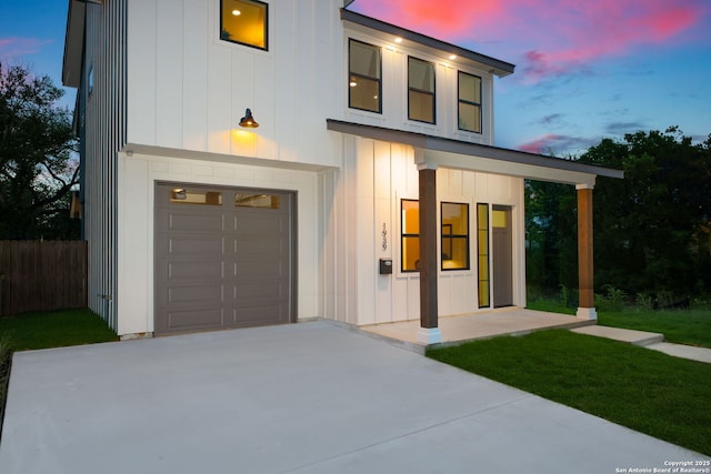 1939 W French Pl, San Antonio, TX 78201 - modern home with an attached garage, concrete driveway, and board and batten siding