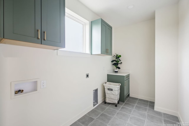 1939 W French Pl, San Antonio, TX 78201 - laundry area with cabinet space, hookup for an electric dryer, washer hookup, and light tile patterned flooring