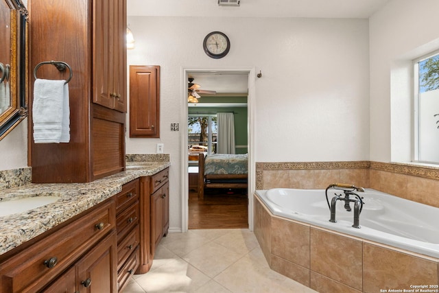 19502 Encino Bow, San Antonio, TX 78259 - ensuite bathroom with healthy amount of natural light, a garden tub, double vanity, and a ceiling fan