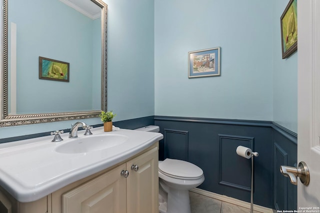 19502 Encino Bow, San Antonio, TX 78259 - bathroom with wainscoting, a decorative wall, vanity, tile patterned flooring, and crown molding