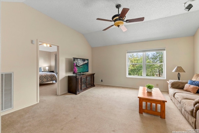 19502 Encino Bow, San Antonio, TX 78259 - living room with vaulted ceiling, light carpet, ceiling fan, and a textured ceiling