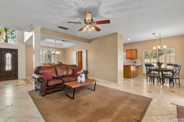 19502 Encino Bow, San Antonio, TX 78259 - living area with a chandelier, light tile patterned floors, ceiling fan, and a textured ceiling