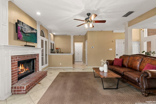 19502 Encino Bow, San Antonio, TX 78259 - living room with decorative columns, light tile patterned floors, a fireplace, ceiling fan, and recessed lighting