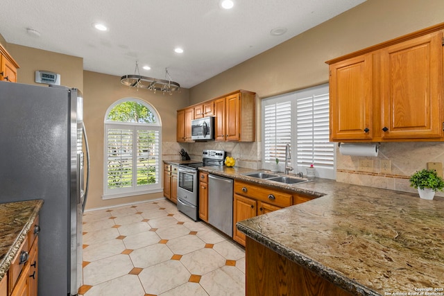 19502 Encino Bow, San Antonio, TX 78259 - kitchen featuring appliances with stainless steel finishes, recessed lighting, decorative backsplash, and brown cabinets