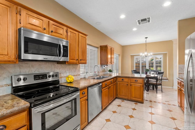 19502 Encino Bow, San Antonio, TX 78259 - kitchen featuring appliances with stainless steel finishes, a chandelier, tasteful backsplash, a peninsula, and recessed lighting