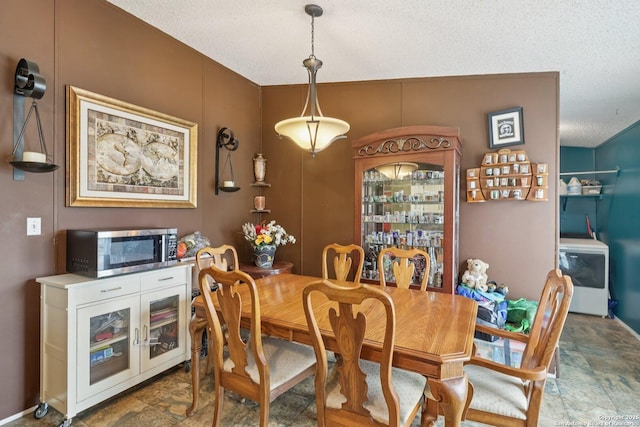 1111 Valeria, Marion, TX 78124 - dining area featuring washer / dryer, a textured ceiling, and stone finish floors