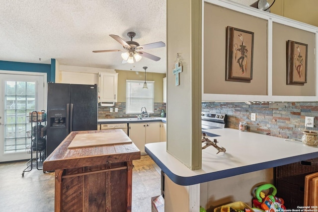 1111 Valeria, Marion, TX 78124 - kitchen featuring black fridge with ice dispenser, decorative backsplash, plenty of natural light, stainless steel electric range oven, and a textured ceiling