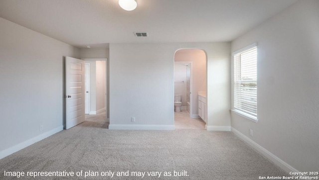 21034 Millstream Bnd, San Antonio, TX 78266 - unfurnished bedroom with arched walkways, light colored carpet, baseboards, and ensuite bath