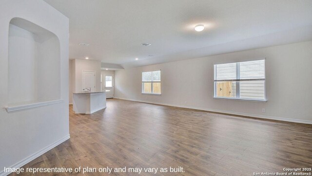 14807 Hooded Merganser, San Antonio, TX 78253 - unfurnished living room featuring wood finished floors, baseboards, and recessed lighting