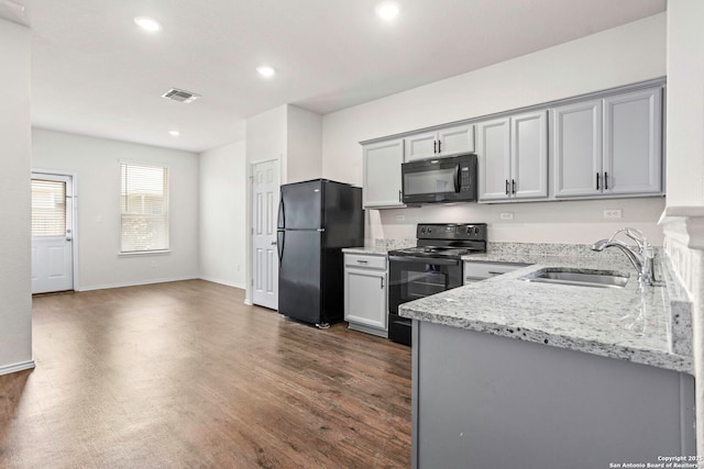 759 Crested Iris, New Braunfels, TX 78130 - kitchen featuring black appliances, recessed lighting, light stone countertops, gray cabinetry, and dark wood finished floors