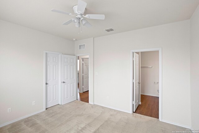 759 Crested Iris, New Braunfels, TX 78130 - unfurnished bedroom with carpet, a closet, ceiling fan, and a walk in closet