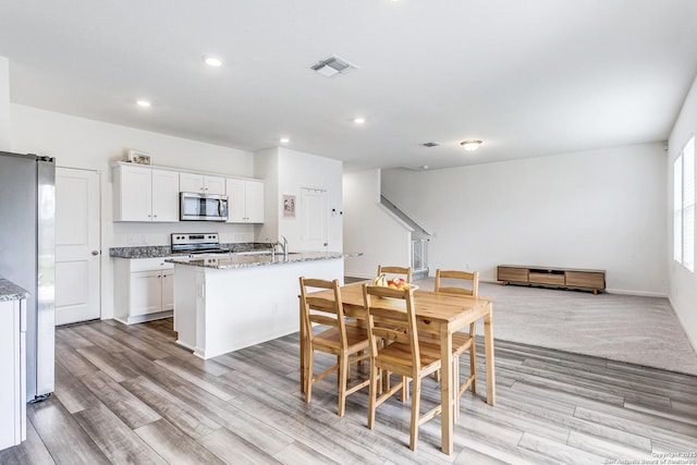 5323 Flying Hooves, San Antonio, TX 78222 - dining room with light wood-style floors and recessed lighting