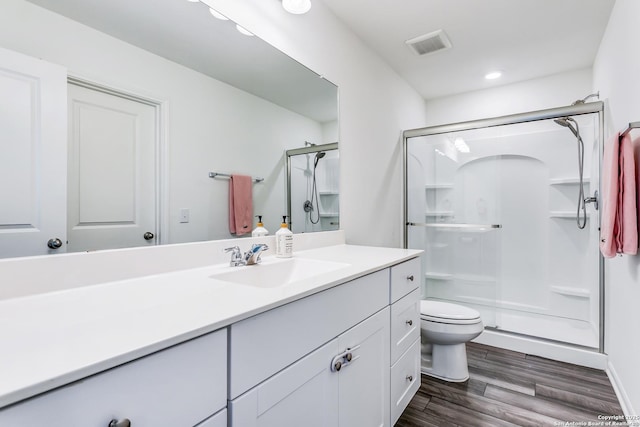 5323 Flying Hooves, San Antonio, TX 78222 - bathroom featuring a stall shower, vanity, wood finished floors, and recessed lighting