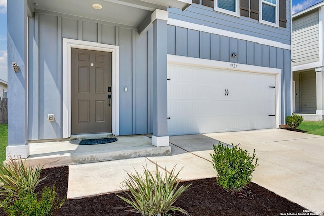 5323 Flying Hooves, San Antonio, TX 78222 - entrance to property with board and batten siding, driveway, and a garage