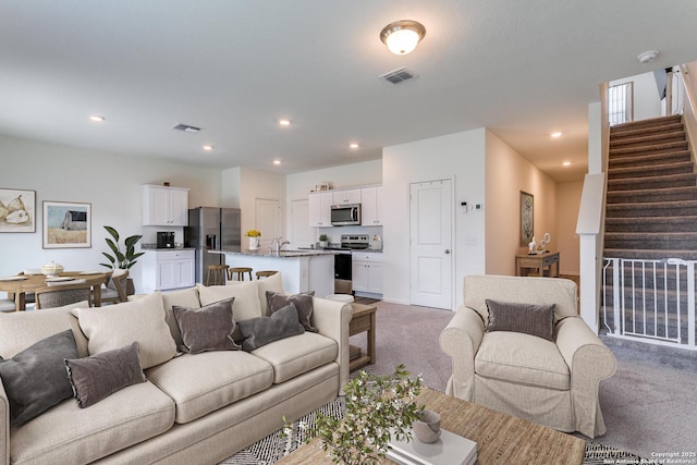 5323 Flying Hooves, San Antonio, TX 78222 - living area featuring carpet flooring, stairs, and recessed lighting