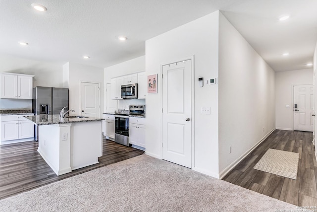 5323 Flying Hooves, San Antonio, TX 78222 - kitchen with stainless steel appliances, white cabinetry, dark wood-type flooring, an island with sink, and recessed lighting