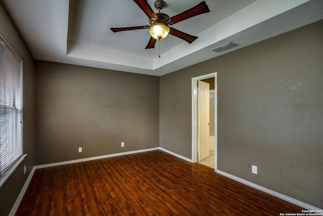 15306 Spring Dew, San Antonio, TX 78247 - empty room featuring wood finished floors, ceiling fan, and a tray ceiling