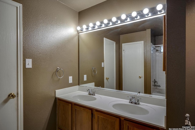 15306 Spring Dew, San Antonio, TX 78247 - bathroom featuring double vanity, a textured wall, and bathing tub / shower combination