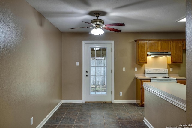 15306 Spring Dew, San Antonio, TX 78247 - kitchen featuring white range with electric cooktop, under cabinet range hood, light countertops, a ceiling fan, and brown cabinetry