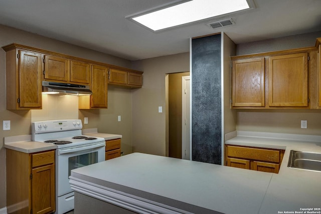 15306 Spring Dew, San Antonio, TX 78247 - kitchen featuring electric range, under cabinet range hood, light countertops, and brown cabinetry